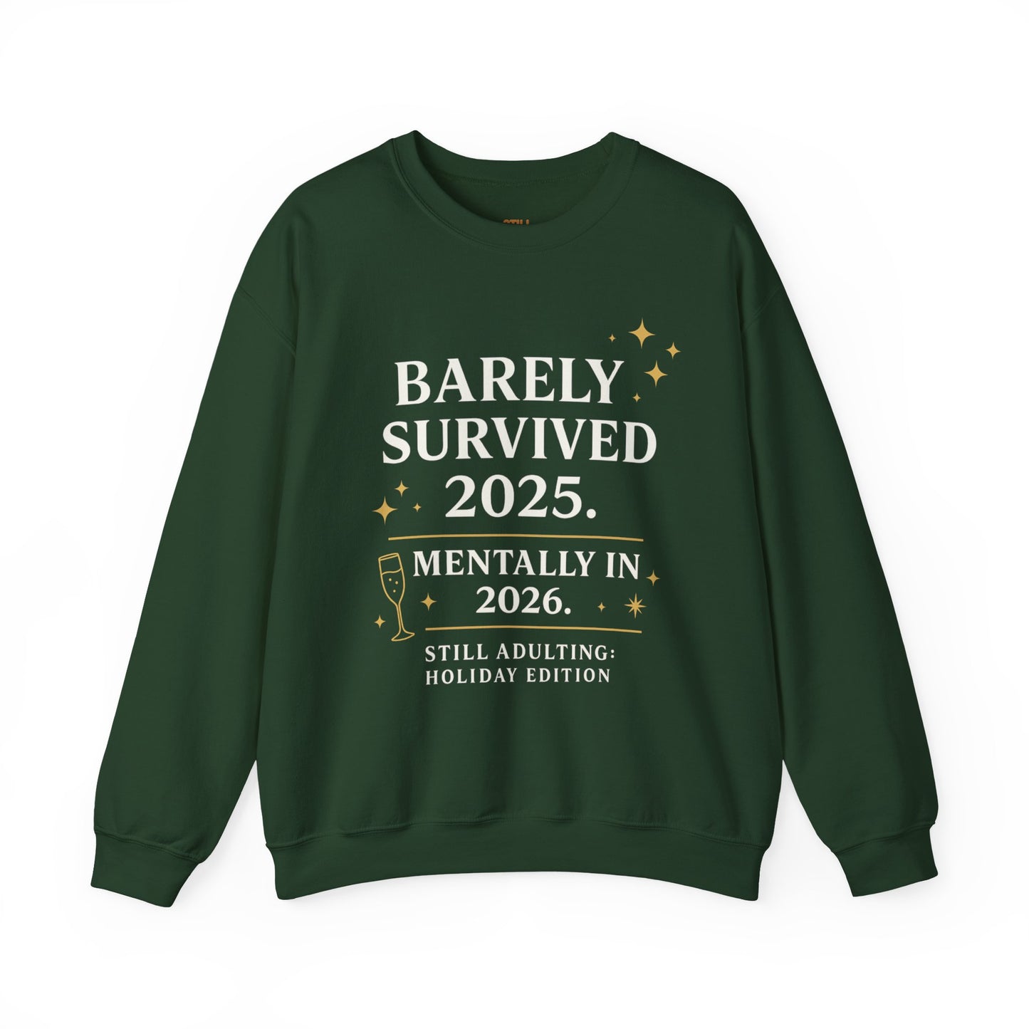 Green crewneck sweatshirt with white and gold text that reads “Barely Survived 2025. Mentally in 2026. Still Adulting: Holiday Edition.”