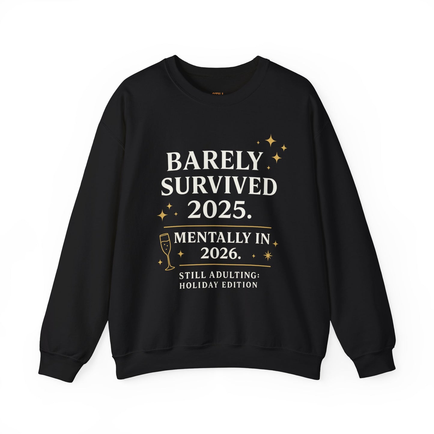 Black crewneck sweatshirt with white and gold text that reads “Barely Survived 2025. Mentally in 2026. Still Adulting: Holiday Edition.”