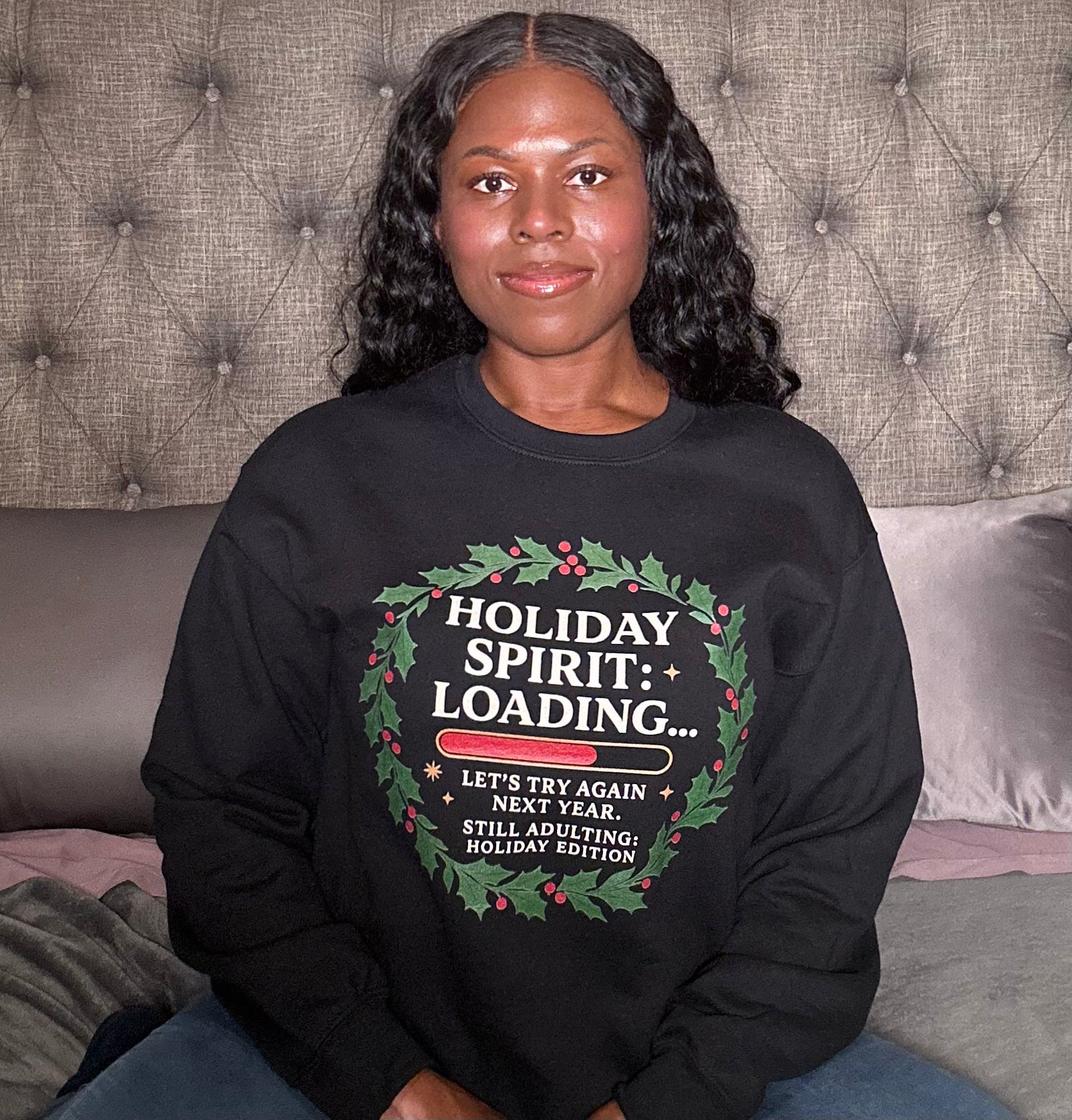 Cozy lifestyle shot woman wearing holiday sweatshirt in bedroom